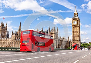 Red bus on Westminster bridge next to Big Ben in London, the UK.