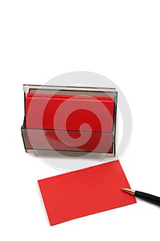 Red Business (blank) card on White with pen.
