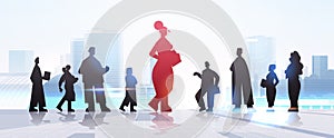 red businesswoman leader silhouette standing in front of businesspeople group leadership business competition