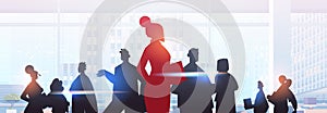 red businesswoman leader silhouette standing in front of businesspeople group leadership business competition
