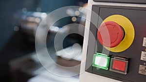 Red button of control panel machine processing metal, industrial background