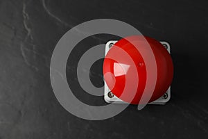 Red button of nuclear weapon on black background, top view with space for text. War concept