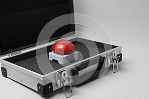 Red button of nuclear weapon in suitcase on white background. War concept