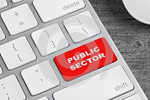 Red button with text Public Sector on computer keyboard, closeup