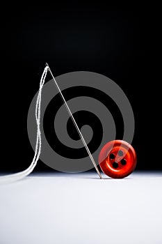 Red button thread needle isolated fashion design concept