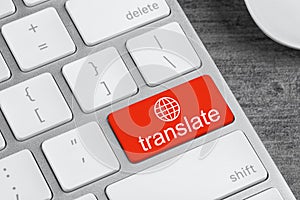 Red button with word TRANSLATE on computer keyboard, closeup view