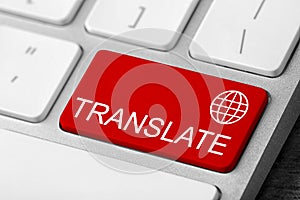 Red button with word TRANSLATE on computer keyboard, closeup view