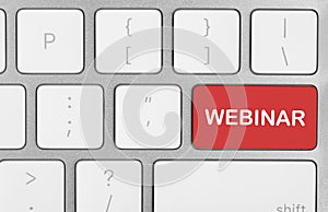 Red button with word Webinar on computer keyboard, top view