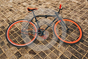Red bycicle is on the square floor