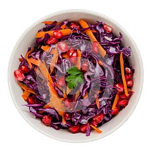 Red cabbage coleslaw with carrots and pomegranate in a white bowl isolated on white background. Low calorie diet concept