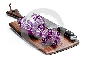 Red cabbage with a knife on a wooden chopping board isolated on white