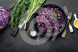 Red cabbage salad with fresh green onion and dill. Vegetarian dish