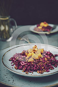 Red cabbage salad with fried apples caramelized with cinnamon