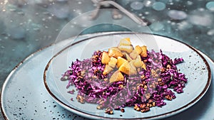 Red cabbage salad with fried apples caramelized with cinnamon