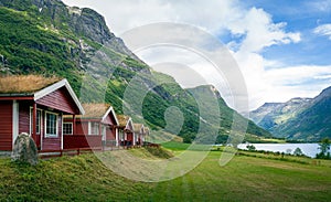 Red cabins with grass on the roofs, Norway