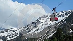 Red cable car in the background of the mountains Old red cable car at mountain.