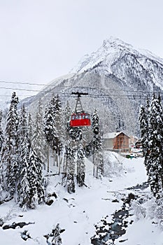 Red cable car on a background of snow mountains