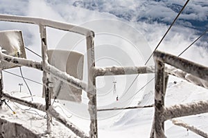 Red cable car descend from mountain peak