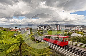 Red cable car moving up the mountain in Wellington