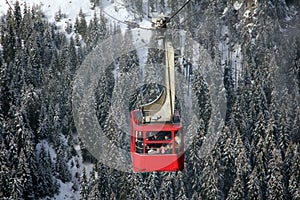 Red cable car over the mountains