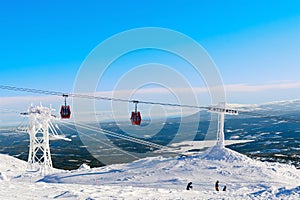 Red cable car in a ski resort in the Alps. Red gondola funicular in a ski resort, sweden, frosty sunny day