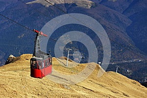 Red cable car transportation at 2000m in Bucegi Mountains, autumn season, Sinaia, Romania