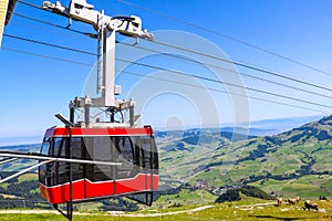 Red cable car from Wasserauen to Ebenalp mountain in the Swiss Alps in Appenzell region, Switzerland