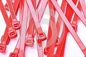 Red cable ties. Commercial photo on white background.