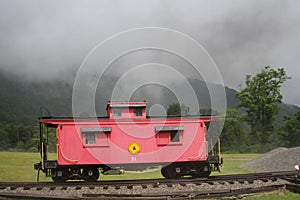 Red caboose foggy mountain