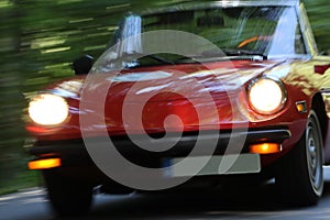 Red cabrio oldtimer in fast motion