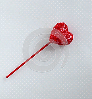 Red cakepop, heart shape, blue background