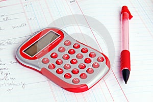 Red calculator on a notebook