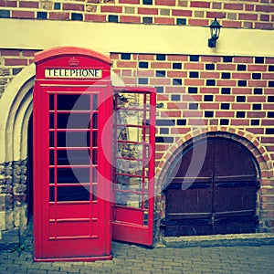 Red call-box on a background a brick wall