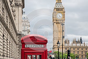 Red call box at Parliament square near Big Ben in London photo