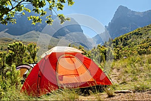 Red camping tent in misty mountains