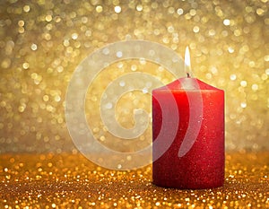 Red candle in festive golden glittery lights background