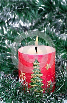 Red candle and green tinsel