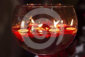 Red candle lights in a big glassess for Valentine day