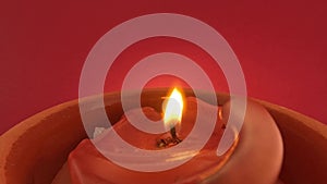 Red candle lit against red background blown out with smoke, 4k