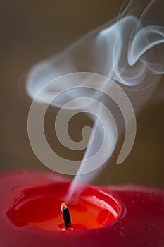 Red candle with smoke