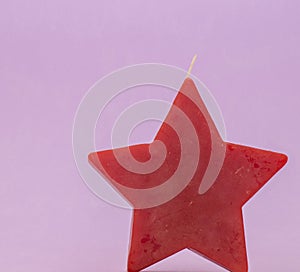 Red candle star on purple background