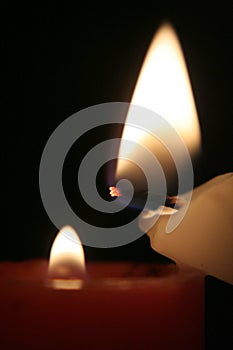 Red candle and white candle with flames