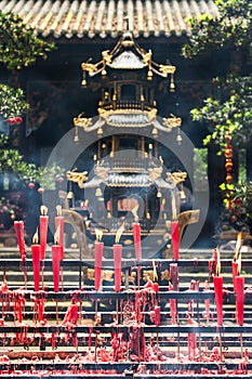 Red candles burning in a buddhist temple