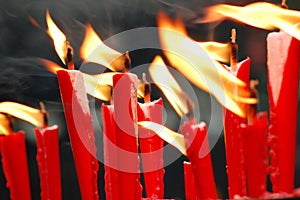 Red candles burning in the temple