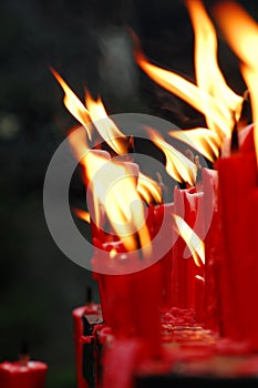 Red candles burning in the temple