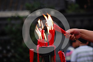 Red candles burning in the temple