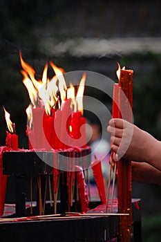 Red candles burning in the temple