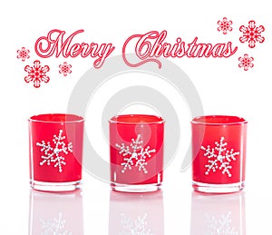 3 red candles, candle holders with crystal snowflakes isolated on reflective white perspex background photo