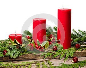 Red candles with cedar boughs