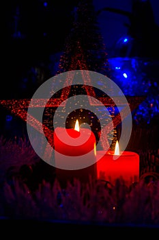 Red candles on a dark background.